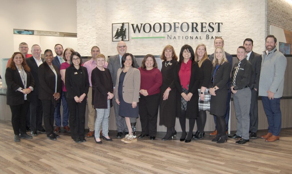 Bank employees gather with representatives from The City of Conroe and the Conroe - Lake Conroe Chamber of Commerce during the soft opening of the newly re-built Woodforest National Bank building in Downtown Conroe. Photo by Liz Grimm.