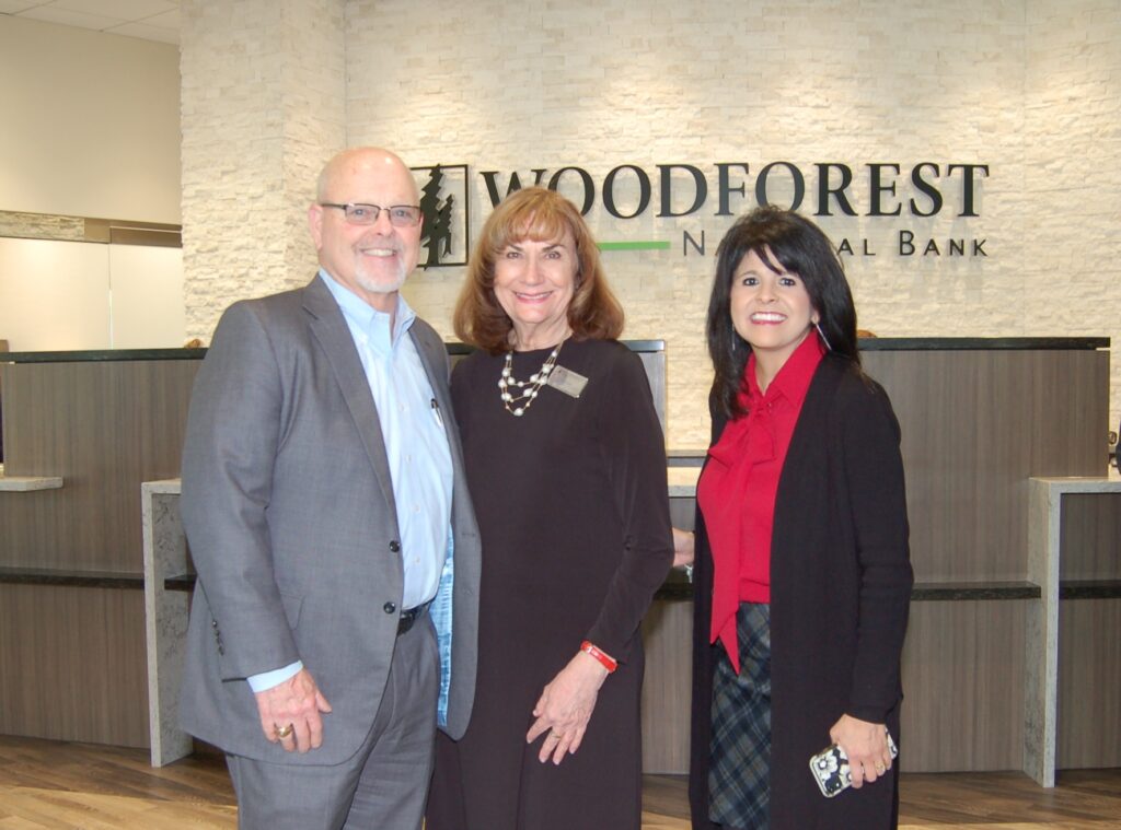 Pictured at the soft opening of the newly re-built Woodforest National Bank building in Downtown Conroe are bank representatives Jay Dreibelbis, President and CEO; Linda O’Dell, Conroe Downtown Branch Manager; and Patricia Brown, President of Conroe. (Photo by Liz Grimm)